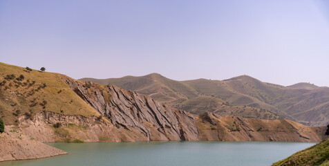 A mountain range with a large body of water in the foreground