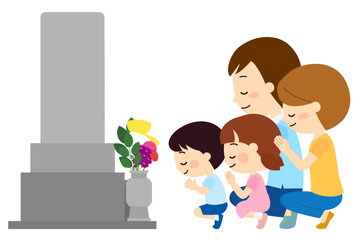 墓参りに来て拝む家族