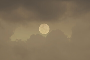 Full moon with clouds in the sky.