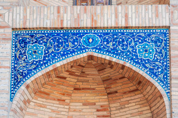 ancient ceramic tile with a traditional Arabic pattern Uzbek ornament decorates the wall portal of...