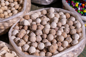 A bag of white and brown balls sits on a table