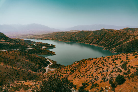 A beautiful lake surrounded by mountains and a dry, barren landscape