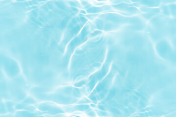 Blue water with ripples on the surface. Defocus blurred transparent blue colored clear calm water surface texture with splashes and bubbles. Water waves with shining pattern texture background.