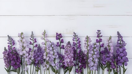 Naklejka premium Violet flowers on a white wooden background
