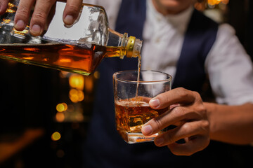 Bartender pouring Whiskey, on  bar