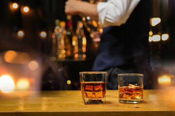 Bartender pouring Whiskey, on  bar