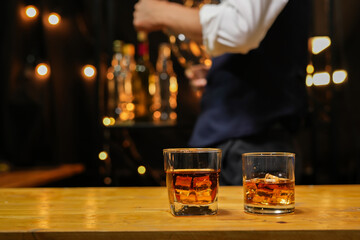 Bartender pouring Whiskey, on  bar