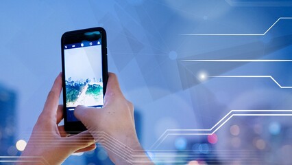 Man capturing an image of the city from the rooftop