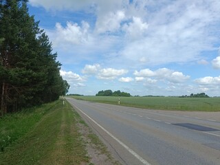 Road in countryside. Asphalt two way road. Forest is growing around road. Countryside.