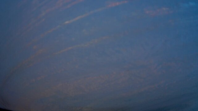 Scraping ice from a car windscreen, viewed from inside the car