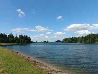 Bubiai lake during sunny day. Lake with small waves. Sunny day with white and gray clouds in sky. Nature. Bubiu ezeras.