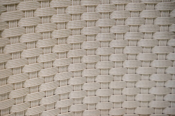 A beautifully crafted weaving pattern showcases its intricate and geometric design, blending traditional craftsmanship with modern aesthetics. The interlaced threads form a symmetrical and detailed