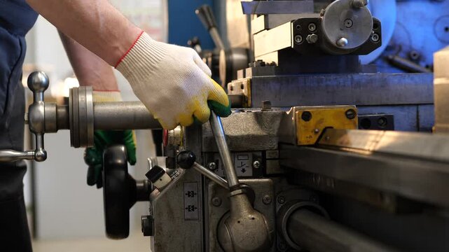 close-up man worker at a lathe starting to work. Starting a lathe, starting work