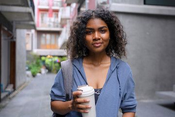 Young Black student woman is living in city.