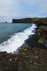 Black sand beach Reynisfjara with view over to Dyrholaey on south iceland in summer