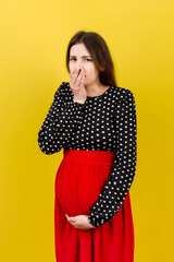 Pregnant woman suffering from toxicosis. Toxicosis Of Pregnancy. Pregnant Lady Feeling Sick Having Nausea Standing On Colored isolated Background. Free Space