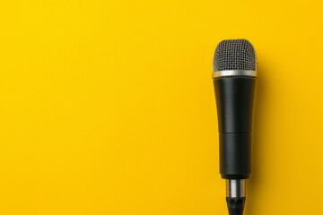 Black Microphone on Yellow Background
