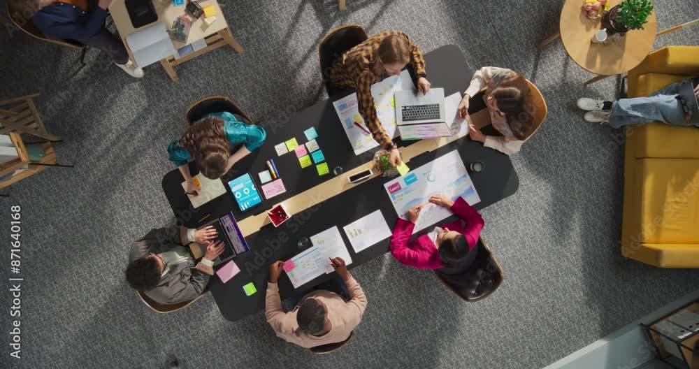 Fototapete top down view of a team meeting in a conference room of a technological startup office, working on l