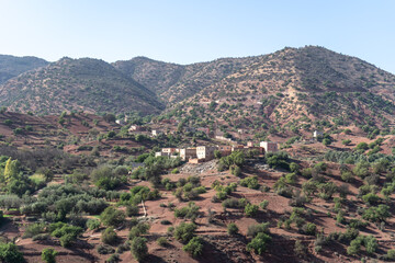 Obraz premium Morocco semi-deserts and mountains, north africa nature, Moroccan stone desert, red hills, villages and argan trees