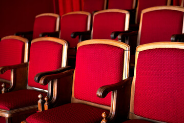 Fototapeta premium red empty seats for spectators in the theater or cinema close-up
