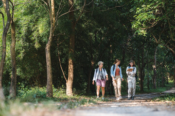 Fototapeta premium Embrace Adventure in Nature: Young Women Enjoying Summer Vacation with Hiking Backpacks, Journey of Freedom and Leisure in Wild Forests, Outdoor Trekking and Travel for Ultimate Landscape Exploration