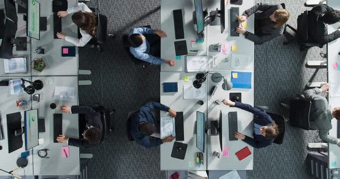 Top Down View Of Diverse Colleagues Working In Corporate Office Of Law Firm. Using Desktop Computers, Discussing Documents, Analyzing Data. Concept Of Teamwork And Professional Business Environment.