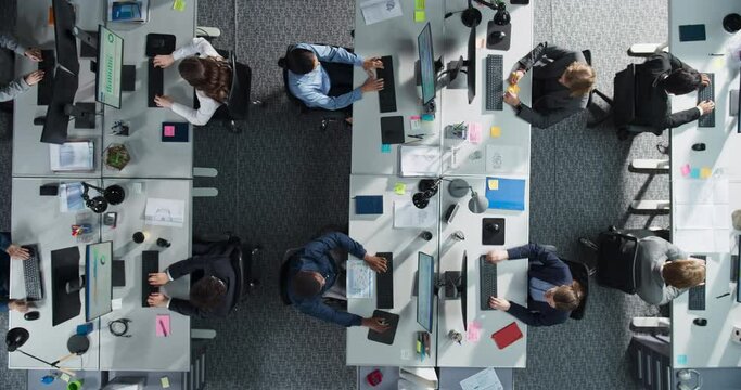 Top Down View: Multiethnic Male And Female Colleagues Using Desktop Computers In The Fintech Startup Office. Managers, Financial Analysts Working, Analyzing Data On Graphs And Charts, Creating Reports