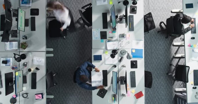 Timelapse of a Multicultural Team in a Corporate Office, Completing Tasks on Computers and Passing Around Financial Documents. Productive And Dynamic Workspace Of Venture Capital Firm Concept.