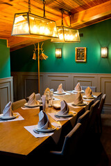 Restaurant interior with a table served with dishes and artificial lighting.