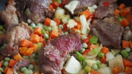 Stir-fry meat and vegetables in an iron skillet. wok stir fry with selective focus