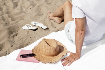 Png beach towel mockup with senior woman summer fashion shoot