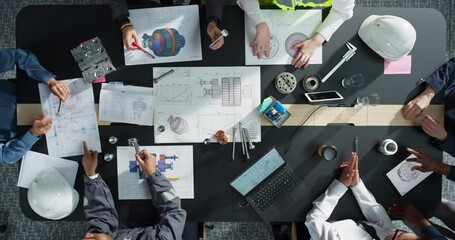 Top Down View: Diverse Team of Male And Female Engineers and Business Professionals Working on Industrial Machinery Blueprints, Using Tablet, Laptop In Corporate Office. Teamwork Of Specialists. - Powered by Adobe
