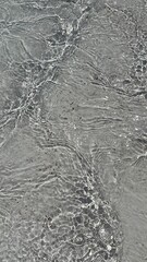 Trendy summer nature banner. Defocused liquid clear water surface texture with splashes bubbles with copy space. Water waves in sunlight background.	
