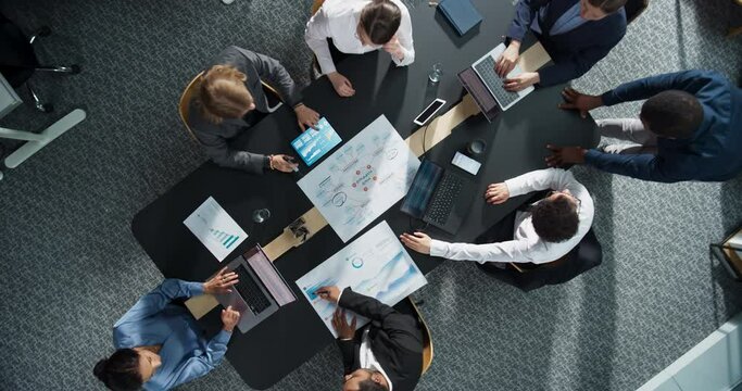 Top Down View, Zoom Out: Diverse Professionals Working on Business Statistics Reports and Project Mindmap in an Office. Discussion and Data Analysis on Laptops and Charts. Teamwork, Innovation Concept