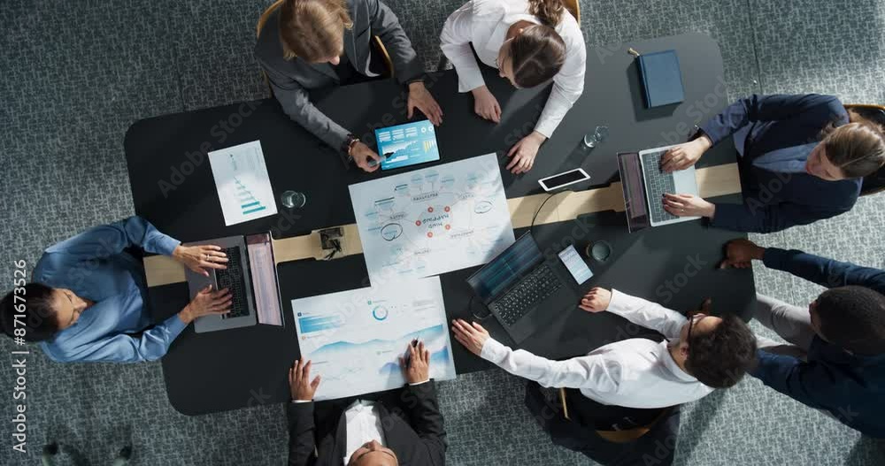 Fototapete Zoom In Top Down View: Diverse Team of Professional Managers And Specialists Analyzing Business Data and Strategies in an Office. Collaboration Of Colleagues With Laptop Computers, Mindmap, And Graphs