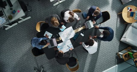 Top Down View Of Diverse Team Of Business Specialists And Managers With Laptops Entering The Conference Room And Sitting Behind Table To Discuss Financial Data And Sales Reports In Corporate Office.