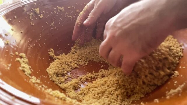 slow motion of chef hands preparing cous cous traditional North Africa wealth semola dish