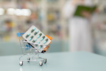 Medicine on shopping trolley in drug store. pharmacy online concept.