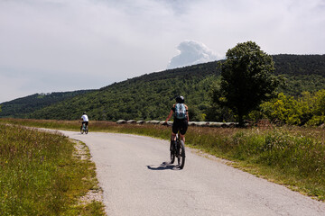 Two road cyclists, male and female on the road