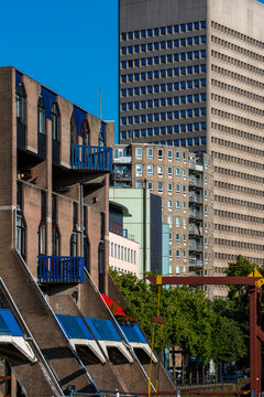 A mix of old and new buildings in an urban setting, depicting various architectural styles and representing the city's dynamic development and diverse history in Rotterdam