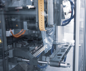 Automatic food packing machine. Food ingredients filling in plastic pouch package.