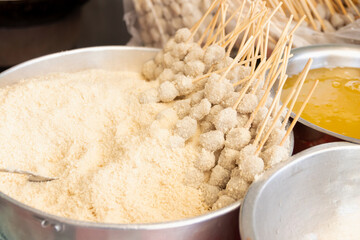 Skewers meat balls with flour, cooking for deep fried crispy meat ball served with sweet and spicy...