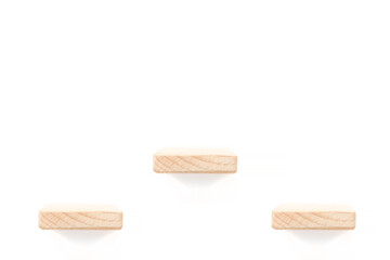 showcase for three items: three wooden shelves over white