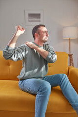 Man with shoulder pain at home.