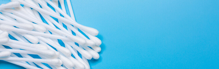 Plastic white cotton bud isolated on blue background, Plastic cotton swabs or cotton buds are on...