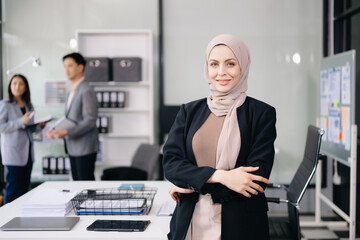 Fototapeta premium Young attractive female office worker business suits smiling at camera in office .