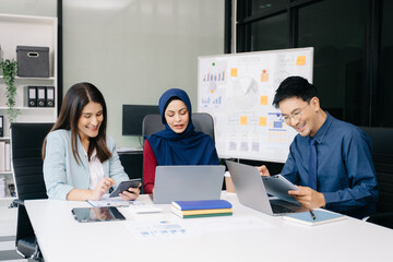 Multiracial group of young creative people in smart casual wear discussing business brainstorming meeting ideas design project.