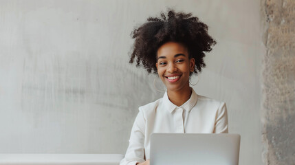black businesswoman working with laptop and smiling at office