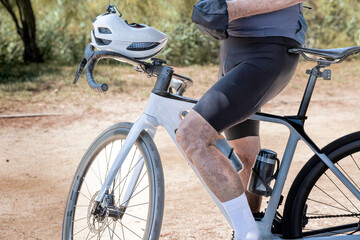 Horizontal close-up of unrecognizable cyclist outdoors.