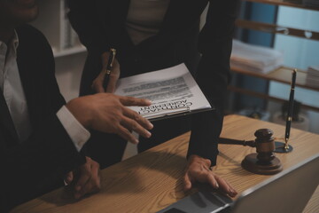 Judge gavel with Justice lawyers having team meeting at law firm background. Concepts of Law and...